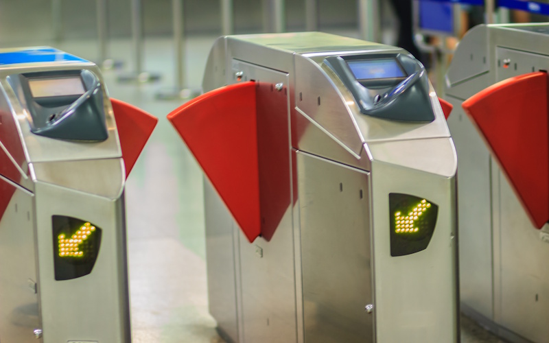 Automatic access control ticket barriers in subway station. View of barrier gate before access in to subway station. Automatic ticket barriers at subway entrance.